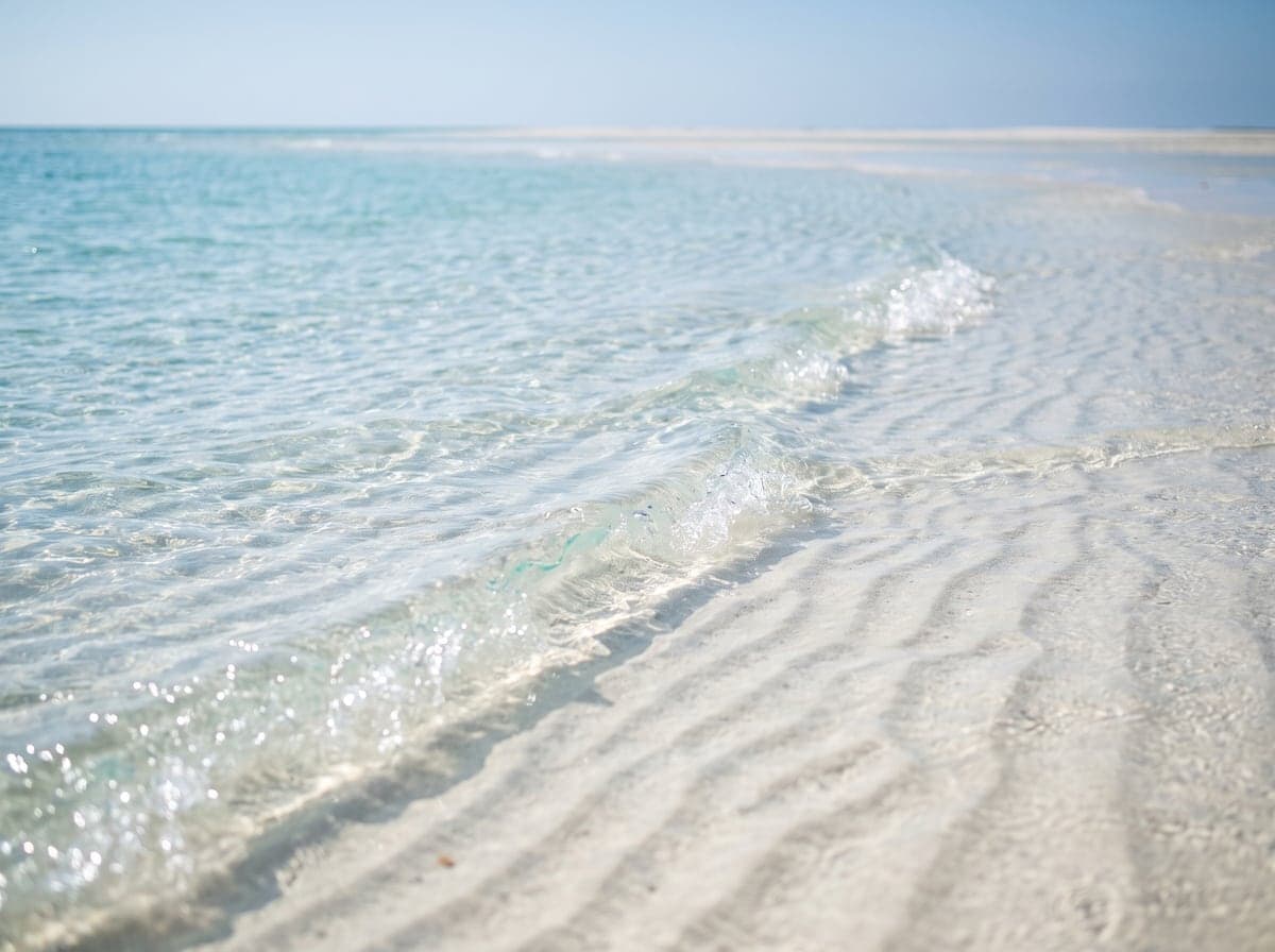 Shallow turquoise water over white sand in the Bahamas